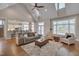 Spacious living room boasts vaulted ceilings, hardwood floors, a ceiling fan, and abundant natural light at 108 Springfield Pl, Hillsborough, NC 27278
