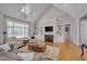 Spacious living area featuring a fireplace, built-in shelving and vaulted ceilings at 108 Springfield Pl, Hillsborough, NC 27278