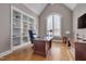 Spacious home office with built-in bookshelves, a large window, and a vaulted ceiling at 108 Springfield Pl, Hillsborough, NC 27278