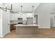 Modern kitchen/living space with stainless appliances and stylish lighting at 109 Averly Ct, Stem, NC 27581