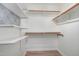 Walk-in closet with custom shelving and geometric wallpaper at 112 Solstice Cir, Cary, NC 27513