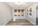 Cozy dining area with wood floors, neutral paint, natural window shades, and ample natural light at 112 Solstice Cir, Cary, NC 27513