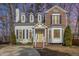 Charming two-story home featuring a mix of brick and siding, complemented by a bright yellow front door at 112 Solstice Cir, Cary, NC 27513