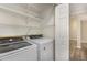 Convenient laundry room features modern washer and dryer and built in shelving for storage at 112 Solstice Cir, Cary, NC 27513