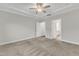Carpeted bedroom features a ceiling fan and white trim, with an ensuite bathroom and walk-in closet at 119 Canary Ct, Raleigh, NC 27610