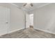 Carpeted bedroom with ceiling fan and an open doorway to another room at 119 Canary Ct, Raleigh, NC 27610