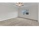 Bright, carpeted bedroom featuring a ceiling fan and natural light from the window at 119 Canary Ct, Raleigh, NC 27610