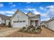 Charming home with light green siding, manicured lawn, and a two-car garage under a partly cloudy sky at 119 Canary Ct, Raleigh, NC 27610