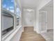 Bright hallway featuring wood floors, white trim, and a glimpse into the exterior at 119 Canary Ct, Raleigh, NC 27610