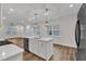 Open kitchen with an island, stainless steel dishwasher and sink, as well as pendant lighting at 119 Canary Ct, Raleigh, NC 27610