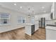 Bright kitchen features stainless appliances, white cabinetry, and an island with pendant lighting at 119 Canary Ct, Raleigh, NC 27610