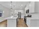 Modern kitchen with stainless steel appliances, bright white island and overhead pendant lighting at 119 Canary Ct, Raleigh, NC 27610