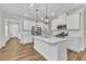 Modern kitchen with stainless steel appliances, bright white island and overhead pendant lighting at 119 Canary Ct, Raleigh, NC 27610