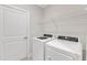 Laundry room featuring a washer, dryer, and overhead wire shelf for storage at 119 Canary Ct, Raleigh, NC 27610