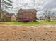 Spacious brick house with a large backyard, a raised red deck, and large trees at 1201 Clematis St, Knightdale, NC 27545
