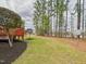 A view of the backyard with its lawn and treeline at 1201 Clematis St, Knightdale, NC 27545