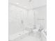Bathroom featuring a glass shower, soaking tub, and white marble-look tile at 1201 Clematis St, Knightdale, NC 27545