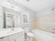 Bright bathroom featuring a tiled shower-tub combo, white toilet, and a vanity with sink at 1201 Clematis St, Knightdale, NC 27545
