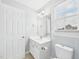 This bathroom features a vanity with a white sink, a toilet, and a window for plenty of natural light at 1201 Clematis St, Knightdale, NC 27545