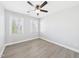 Well-lit bedroom showcasing two windows and laminate wood-look flooring at 1201 Clematis St, Knightdale, NC 27545