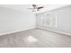An empty, sun-filled bedroom featuring light gray walls and wood-look floors at 1201 Clematis St, Knightdale, NC 27545
