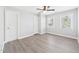 Updated bedroom with laminate flooring, neutral paint, ceiling fan and 2 windows at 1201 Clematis St, Knightdale, NC 27545