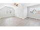 Spacious room with a high ceiling, light gray walls, hardwood floors, and two large windows at 1201 Clematis St, Knightdale, NC 27545