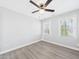 Cozy bedroom featuring neutral paint, two windows and laminate flooring at 1201 Clematis St, Knightdale, NC 27545