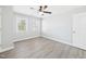 Inviting bedroom featuring two windows and updated gray flooring at 1201 Clematis St, Knightdale, NC 27545