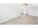 A spacious room with light gray walls and flooring, with an entrance to another room at 1201 Clematis St, Knightdale, NC 27545