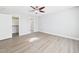 Bedroom with wood-look floors, ceiling fan, and an ensuite bathroom at 1201 Clematis St, Knightdale, NC 27545