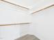 Walk-in closet with white walls, wood-look flooring, and wooden shelves at 1201 Clematis St, Knightdale, NC 27545