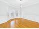 Elegant dining room with hardwood floors, wainscoting, and a bay window allowing ample natural light at 1201 Clematis St, Knightdale, NC 27545