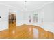 Elegant dining space with hardwood flooring, wainscoting, bay window, and modern chandelier at 1201 Clematis St, Knightdale, NC 27545