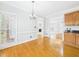 Dining room with hardwood floors, a chandelier, and access to the kitchen and living areas at 1201 Clematis St, Knightdale, NC 27545