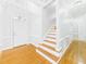 Inviting foyer with hardwood floors, white trim, and a staircase leading to the upper level of the home at 1201 Clematis St, Knightdale, NC 27545