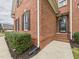 A brick home's exterior view highlighting the front door, manicured bushes, and a well-maintained lawn at 1201 Clematis St, Knightdale, NC 27545