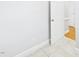 Hallway with door to another room, and view of the tile floor at 1201 Clematis St, Knightdale, NC 27545