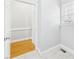Hallway with wood and tile flooring leading to the entry to the laundry room at 1201 Clematis St, Knightdale, NC 27545