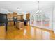 Well-lit kitchen with hardwood floors, a central island, and access to an outdoor deck with windows at 1201 Clematis St, Knightdale, NC 27545