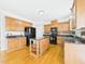 Spacious kitchen features a center island, wooden cabinetry, and black appliances at 1201 Clematis St, Knightdale, NC 27545
