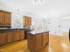 Open kitchen with an island, lots of natural light, and views of the backyard at 1201 Clematis St, Knightdale, NC 27545
