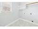 Small laundry room with tile flooring, a window, and washer/dryer hookups at 1201 Clematis St, Knightdale, NC 27545