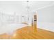 Bright, open living space with a chandelier, fireplace, and combined hardwood and carpeted flooring at 1201 Clematis St, Knightdale, NC 27545
