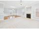 Large living area with a fireplace, chandelier, bay window, and blend of carpet and wood floors at 1201 Clematis St, Knightdale, NC 27545