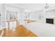 Bright living room with hardwood floors, a fireplace, and large windows showcasing an elegant and airy space at 1201 Clematis St, Knightdale, NC 27545