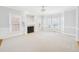 Spacious living room with a fireplace, large windows allowing natural light, and neutral color palette at 1201 Clematis St, Knightdale, NC 27545
