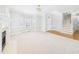 Inviting living room with a fireplace, ample natural light, and a mix of carpet and hardwood flooring at 1201 Clematis St, Knightdale, NC 27545
