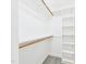 Bright walk-in closet with custom shelving and laminate flooring at 1201 Clematis St, Knightdale, NC 27545