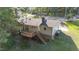 Home with a back deck, lush lawn, and mature trees, perfect for outdoor enjoyment at 1224 Manchester Dr, Raleigh, NC 27609
